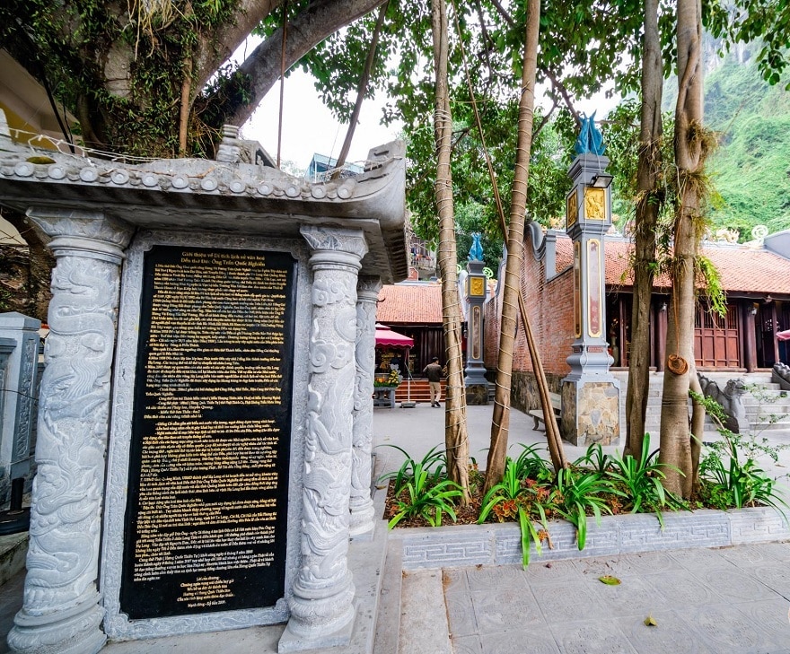 Stone stele at the foot of the banyan tree at Duc Ong Temple