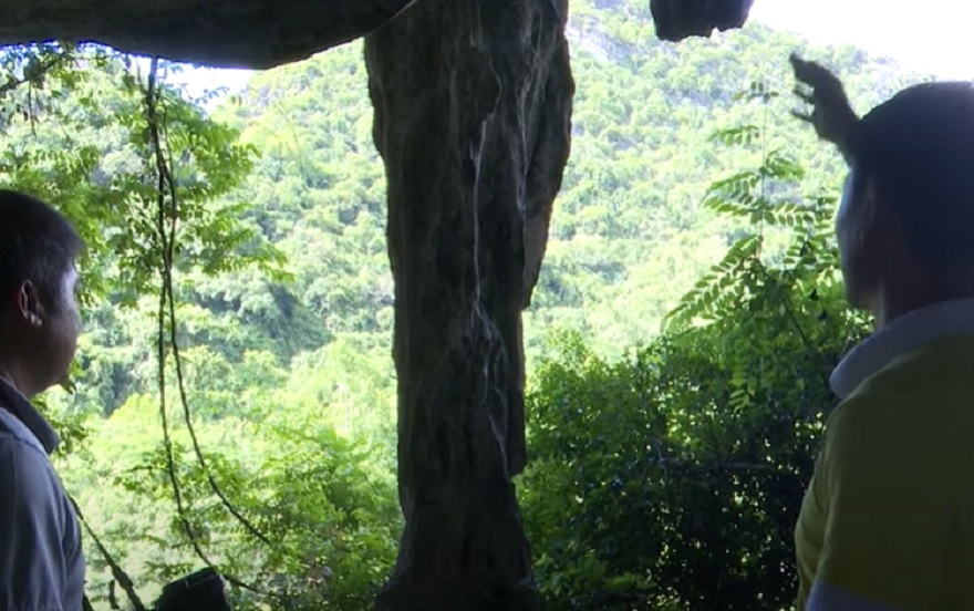 Massive stalagmite and stalactite pillars located right at the cave entrance