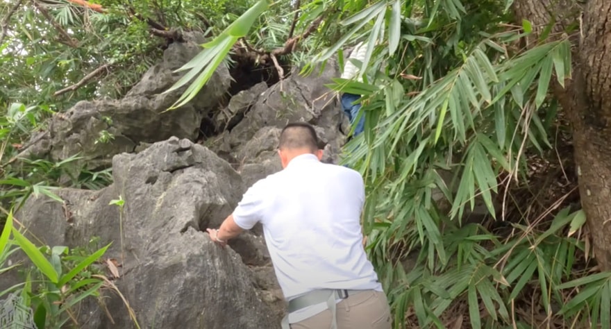 Visitors must scramble across large boulders to continue their ascent
