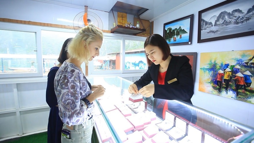 Discerning travelers admiring exquisite pearl creations in the showroom