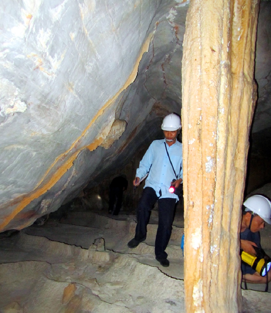 The cave features majestic stalactite formations resembling pillars supporting the grand vault