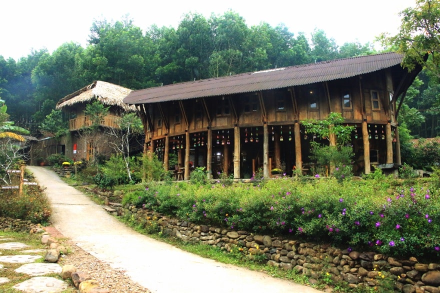 The community house with stylized stilt-house architecture at Ky Thuong Am Vap Farm.