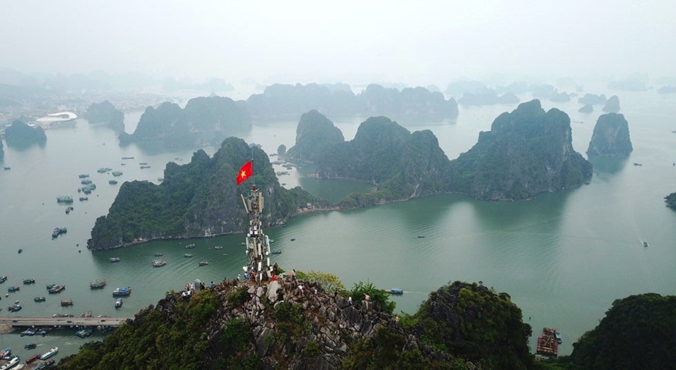 The red flag with a yellow star flutters proudly atop Poem Mountain
