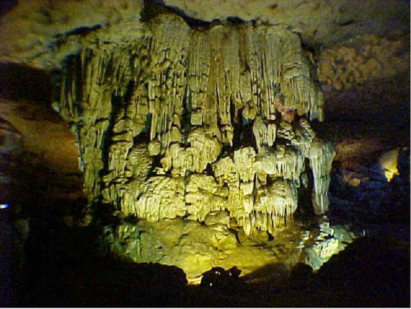 A colossal stone pillar seemingly holding up the entire cavern